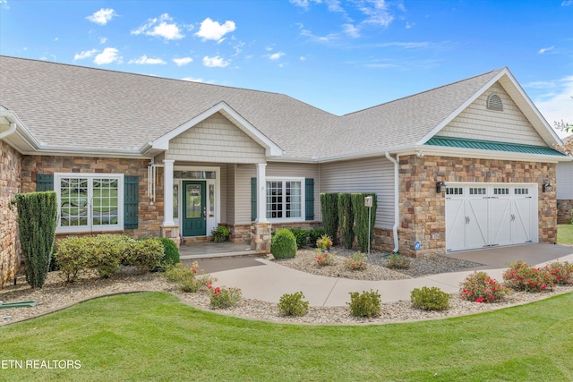 404 Chota Landing Way, Loudon, TN 37774 - craftsman house with stone siding, a shingled roof, a front lawn, and an attached garage