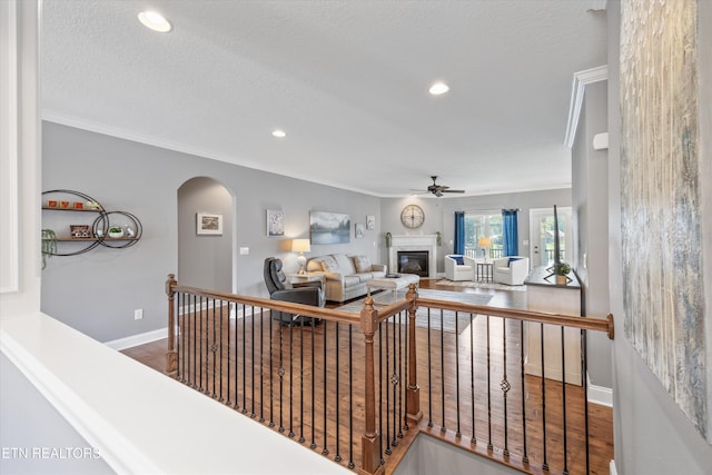 404 Chota Landing Way, Loudon, TN 37774 - living area with a ceiling fan, a glass covered fireplace, arched walkways, ornamental molding, and wood finished floors