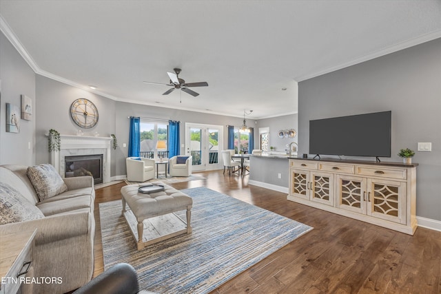 404 Chota Landing Way, Loudon, TN 37774 - living area with crown molding, a ceiling fan, a fireplace, dark wood-style floors, and a chandelier