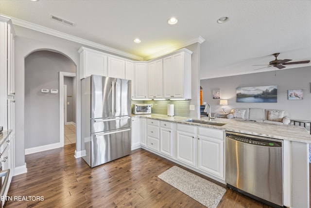 404 Chota Landing Way, Loudon, TN 37774 - kitchen featuring stainless steel appliances, arched walkways, crown molding, open floor plan, and a peninsula