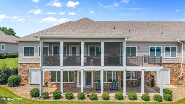 404 Chota Landing Way, Loudon, TN 37774 - back of property with stone siding, a patio area, roof with shingles, and a sunroom