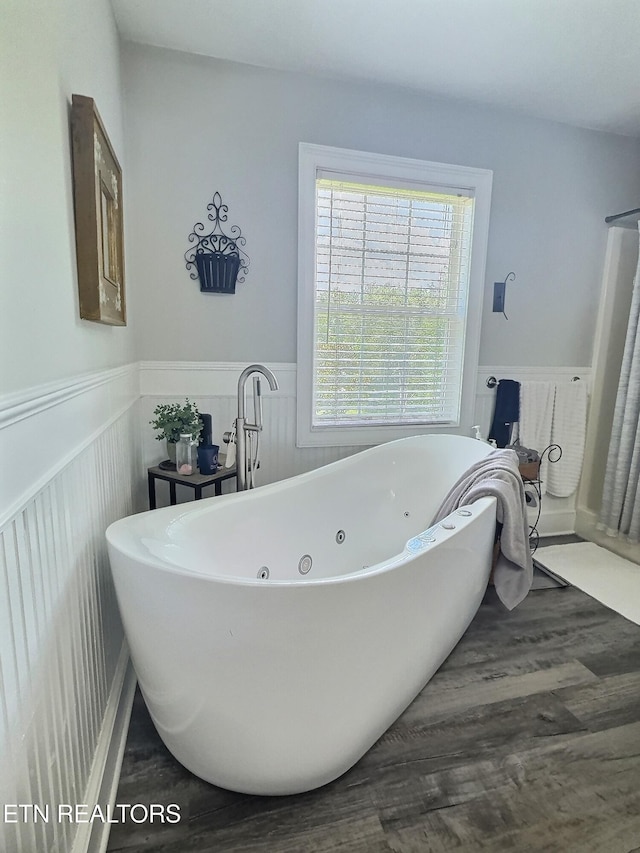 1292 Martin Ln, Lafollette, TN 37766 - bathroom featuring wainscoting, a freestanding tub, and wood finished floors