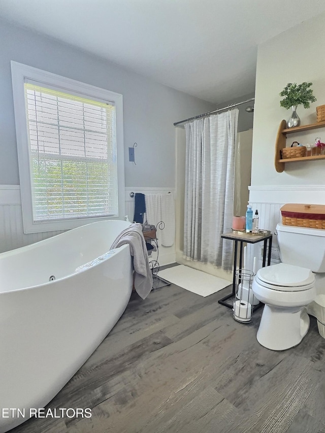1292 Martin Ln, Lafollette, TN 37766 - bathroom featuring wainscoting, wood finished floors, a tub, and a shower with curtain