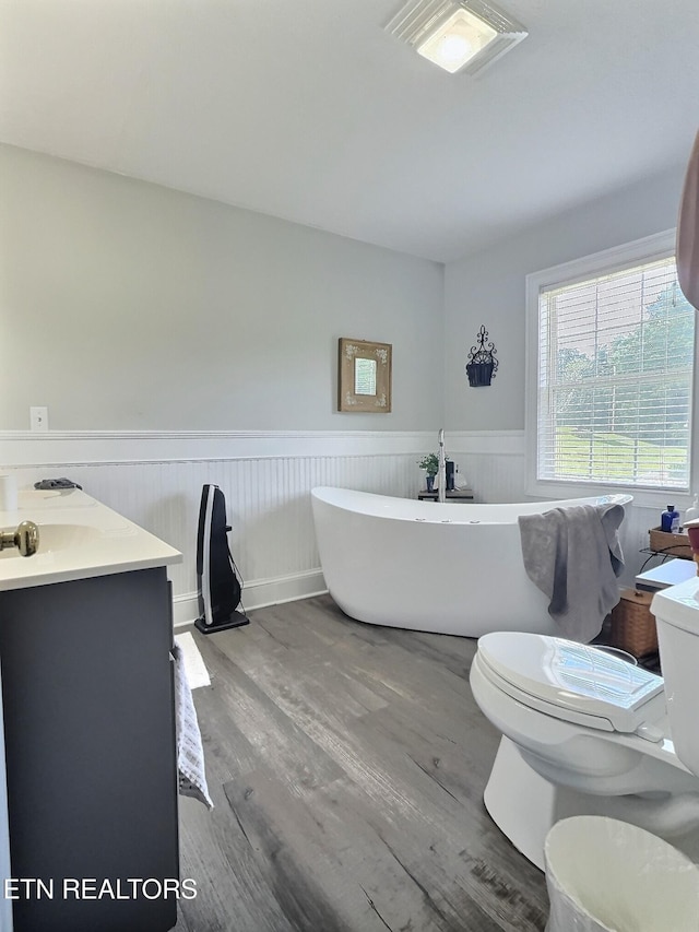 1292 Martin Ln, Lafollette, TN 37766 - full bathroom featuring a soaking tub, wood finished floors, a wainscoted wall, and vanity