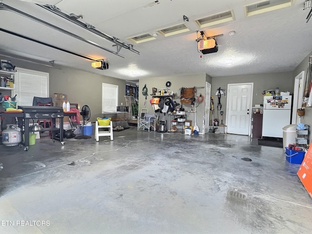 1292 Martin Ln, Lafollette, TN 37766 - garage with freestanding refrigerator and a garage door opener