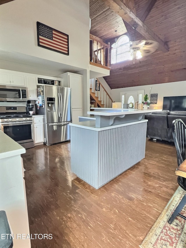 1292 Martin Ln, Lafollette, TN 37766 - kitchen featuring stainless steel appliances, high vaulted ceiling, ceiling fan, a wooden ceiling with exposed beams, and white cabinets