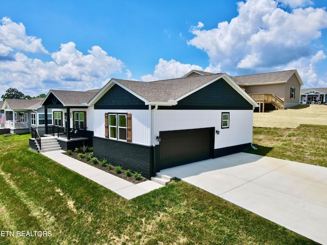 105 Ruby Ln, New Tazewell, TN 37824 - view of front of property with concrete driveway, a garage, a front lawn, and covered porch