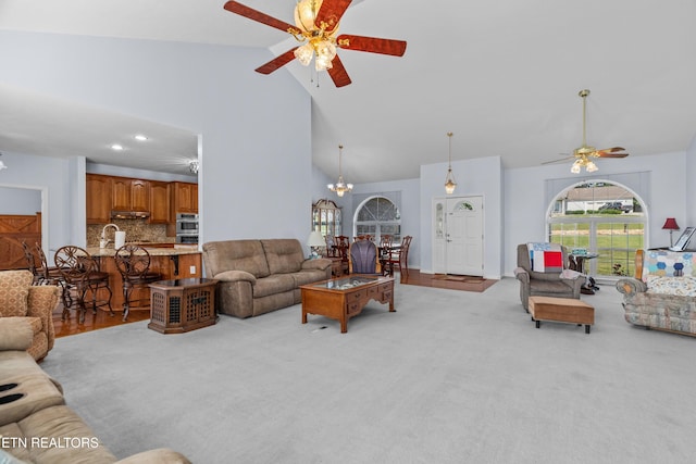 108 Skyline Dr, Dandridge, TN 37725 - carpeted living room with high vaulted ceiling, ceiling fan, and a chandelier