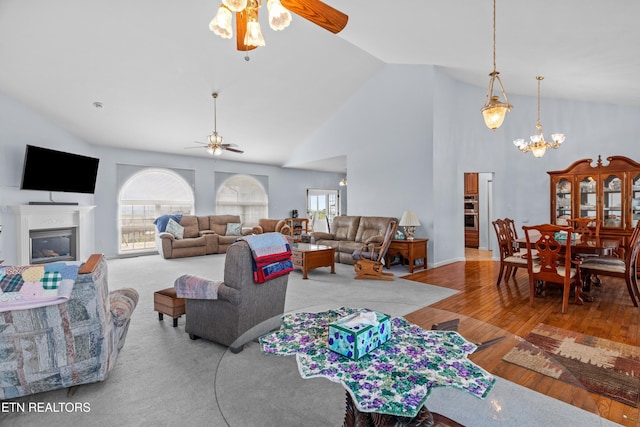 108 Skyline Dr, Dandridge, TN 37725 - living area featuring ceiling fan, a glass covered fireplace, high vaulted ceiling, a chandelier, and wood finished floors