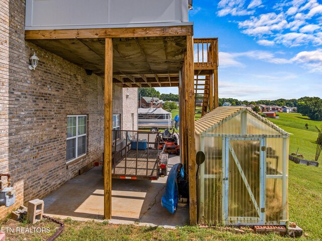 108 Skyline Dr, Dandridge, TN 37725 - view of patio with an exterior structure, an outbuilding, and a carport