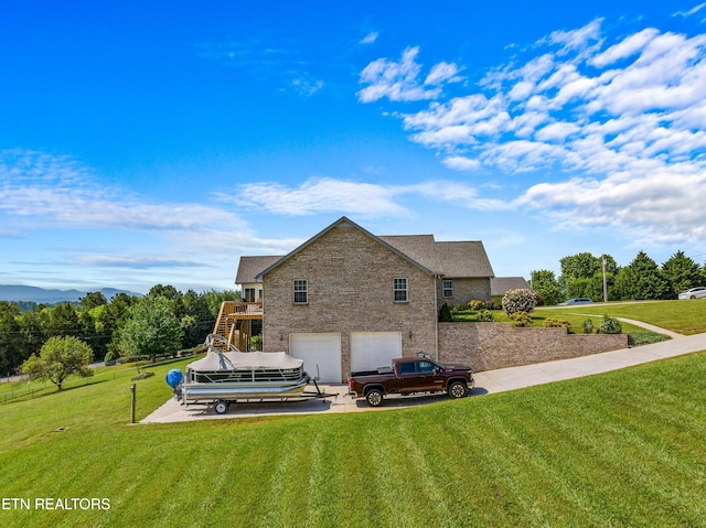 108 Skyline Dr, Dandridge, TN 37725 - rear view of house with stairs, a lawn, an attached garage, and driveway