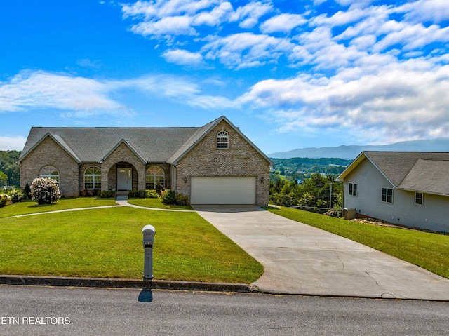 108 Skyline Dr, Dandridge, TN 37725 - view of front of home featuring brick siding, driveway, a front lawn, a mountain view, and a garage