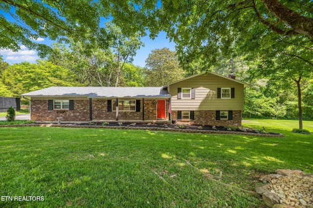 313 Hardwicke Dr, Knoxville, TN 37923 - tri-level home featuring a front yard, brick siding, and a chimney