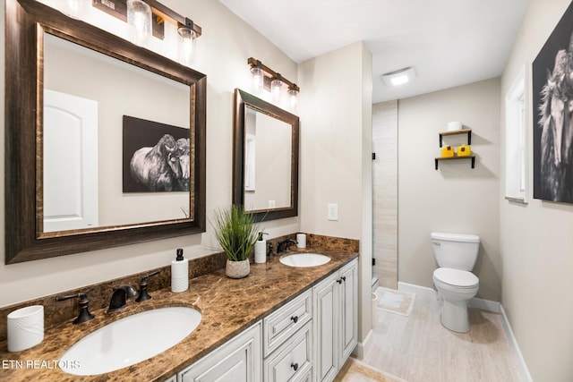 313 Hardwicke Dr, Knoxville, TN 37923 - bathroom featuring double vanity, a shower stall, and wood finished floors