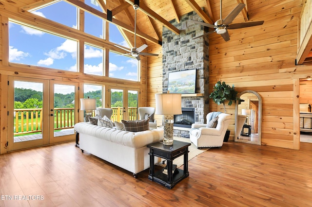 1144 Sanctuary Shores Way, Sevierville, TN 37876 - living area with a ceiling fan, high vaulted ceiling, healthy amount of natural light, a wooden ceiling with exposed beams, and wooden walls