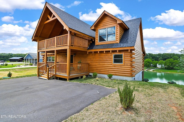 1144 Sanctuary Shores Way, Sevierville, TN 37876 - view of front of property with a balcony, roof with shingles, a water view, log exterior, and a front yard