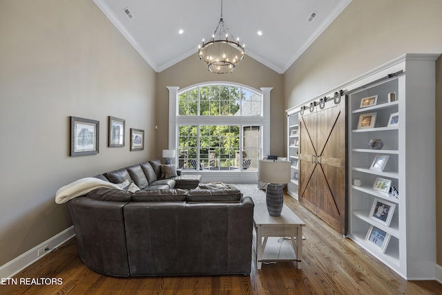12706 Highwick Cir, Knoxville, TN 37934 - living area with ornamental molding, a barn door, a chandelier, wood finished floors, and high vaulted ceiling