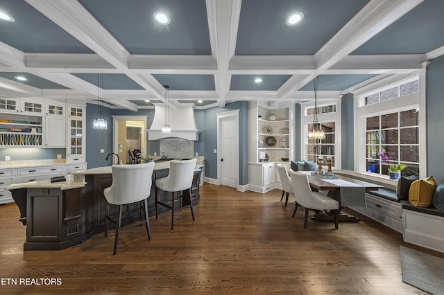 12706 Highwick Cir, Knoxville, TN 37934 - kitchen featuring a chandelier, white cabinets, glass insert cabinets, coffered ceiling, and a breakfast bar