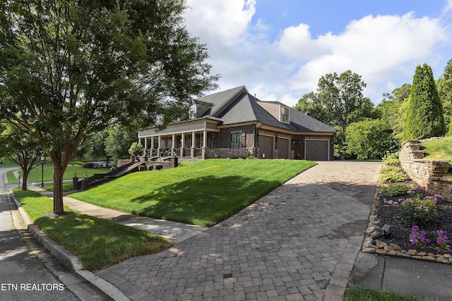 12706 Highwick Cir, Knoxville, TN 37934 - view of front of house with a front lawn, a garage, decorative driveway, a sunroom, and stone siding