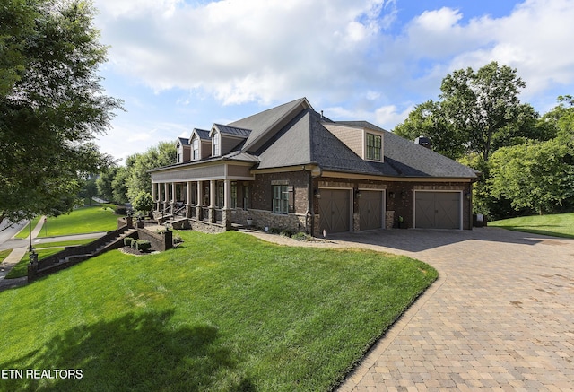 12706 Highwick Cir, Knoxville, TN 37934 - view of front of house featuring decorative driveway, a front yard, a sunroom, a garage, and stone siding