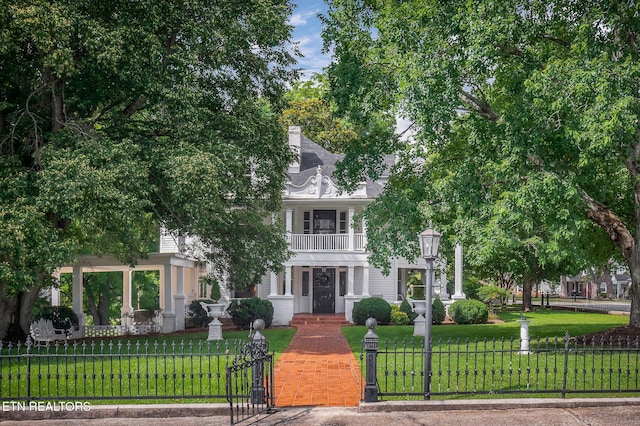 105 N Church St, Sparta, TN 38583 - view of property hidden behind natural elements with a fenced front yard, a balcony, and a gate