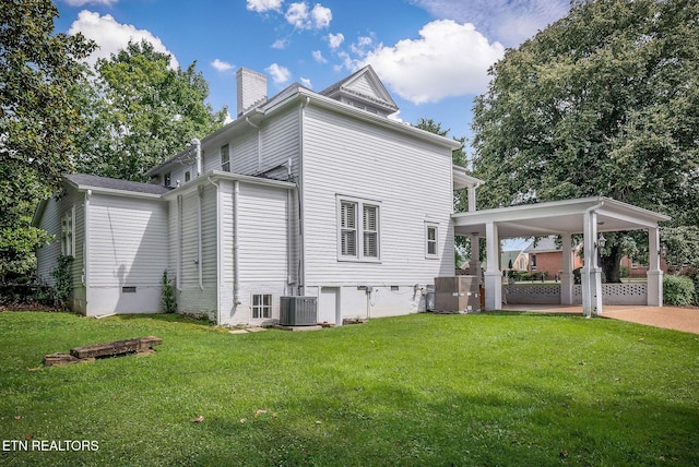 105 N Church St, Sparta, TN 38583 - back of property featuring a chimney, a lawn, and an attached carport