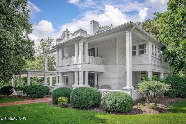 105 N Church St, Sparta, TN 38583 - view of front of house featuring a balcony, a chimney, and a front yard
