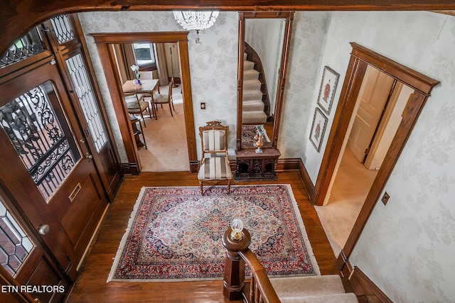 105 N Church St, Sparta, TN 38583 - foyer featuring wood finished floors, stairs, wallpapered walls, a chandelier, and arched walkways