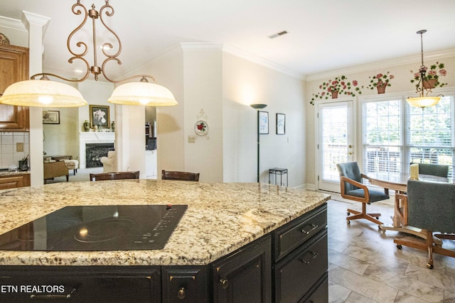 275 Fordham Way, Knoxville, TN 37934 - kitchen with black electric stovetop, dark cabinetry, pendant lighting, light stone countertops, and ornamental molding