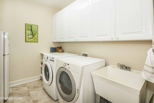 275 Fordham Way, Knoxville, TN 37934 - laundry area with washing machine and dryer, cabinet space, and light marble finish flooring