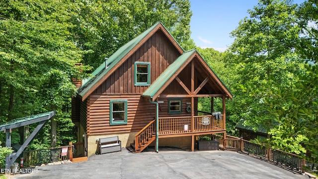 4410 Forest Vista Way, Pigeon Forge, TN 37863 - view of front of house with board and batten siding, log exterior, and a porch