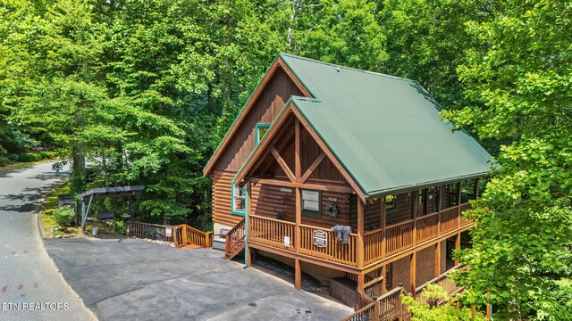 4410 Forest Vista Way, Pigeon Forge, TN 37863 - view of front facade featuring log siding, a metal roof, and asphalt driveway