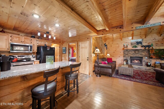 4410 Forest Vista Way, Pigeon Forge, TN 37863 - kitchen with stainless steel appliances, a wood ceiling with exposed beams, hardwood / wood-style flooring, wooden walls, and open floor plan