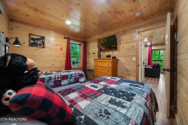 4410 Forest Vista Way, Pigeon Forge, TN 37863 - bedroom featuring wood walls, wooden ceiling, multiple windows, and wood finished floors