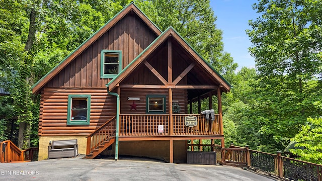 4410 Forest Vista Way, Pigeon Forge, TN 37863 - view of front of home with board and batten siding, covered porch, and log siding