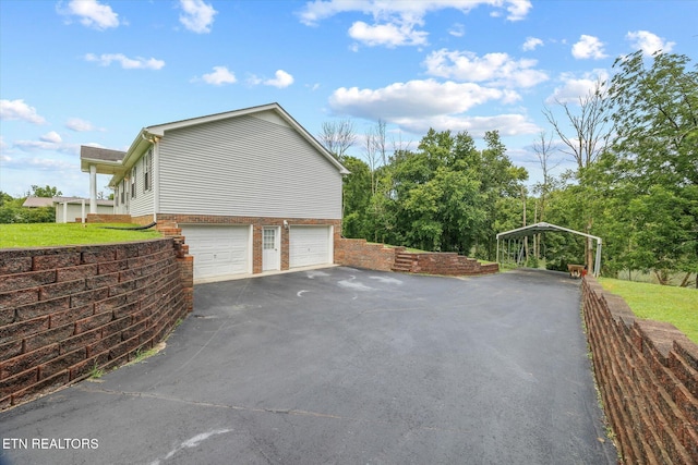 454 Boyd St, Celina, TN 38551 - view of property exterior with an attached garage and asphalt driveway
