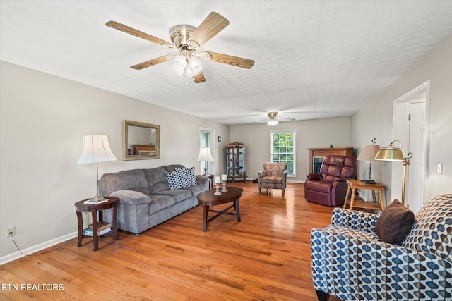 454 Boyd St, Celina, TN 38551 - living room featuring light wood finished floors, a ceiling fan, and a textured ceiling