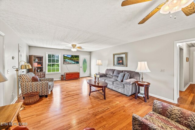 454 Boyd St, Celina, TN 38551 - living room featuring ceiling fan, a textured ceiling, and light wood-style flooring