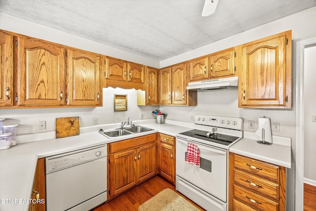 454 Boyd St, Celina, TN 38551 - kitchen with white appliances, under cabinet range hood, dark wood-style flooring, a textured ceiling, and light countertops