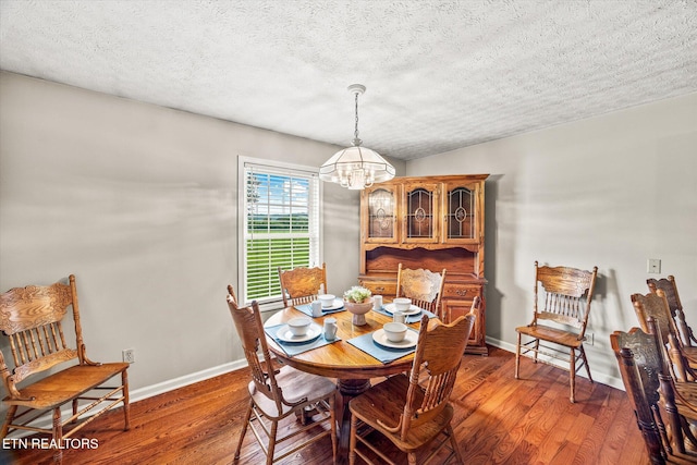 454 Boyd St, Celina, TN 38551 - dining space featuring a chandelier, hardwood / wood-style flooring, and a textured ceiling
