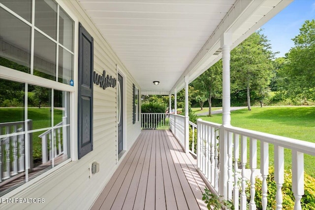 348 Ridge Rd, Caryville, TN 37714 - wooden porch featuring a lawn
