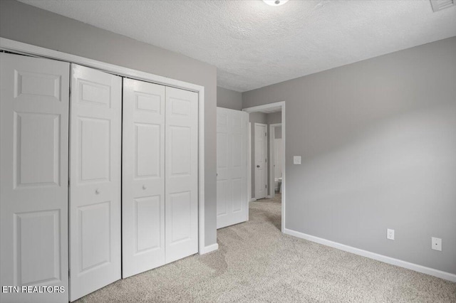 348 Ridge Rd, Caryville, TN 37714 - unfurnished bedroom featuring light carpet, a closet, and a textured ceiling