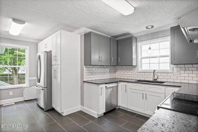 348 Ridge Rd, Caryville, TN 37714 - kitchen with stainless steel appliances, tasteful backsplash, dark tile patterned flooring, crown molding, and pendant lighting