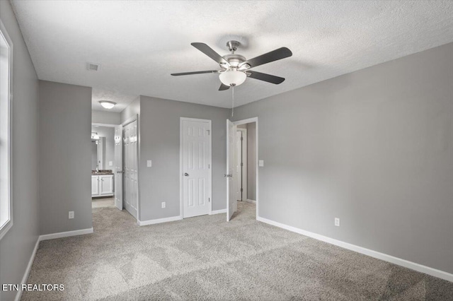 348 Ridge Rd, Caryville, TN 37714 - unfurnished bedroom featuring light carpet, ensuite bathroom, a ceiling fan, and a closet
