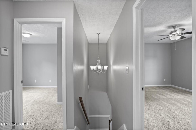 348 Ridge Rd, Caryville, TN 37714 - hallway with an upstairs landing, carpet floors, a textured ceiling, and a chandelier