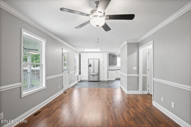 348 Ridge Rd, Caryville, TN 37714 - unfurnished living room featuring healthy amount of natural light, dark wood-type flooring, a textured ceiling, a ceiling fan, and crown molding