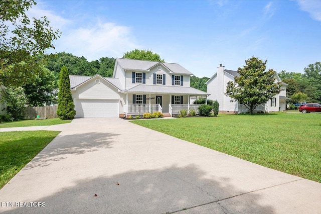 348 Ridge Rd, Caryville, TN 37714 - view of front of house with covered porch, an attached garage, driveway, and a metal roof