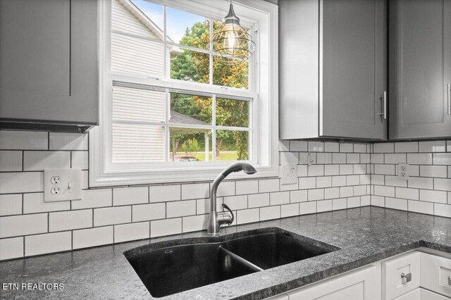 348 Ridge Rd, Caryville, TN 37714 - kitchen featuring tasteful backsplash, gray cabinetry, dark stone countertops, and decorative light fixtures