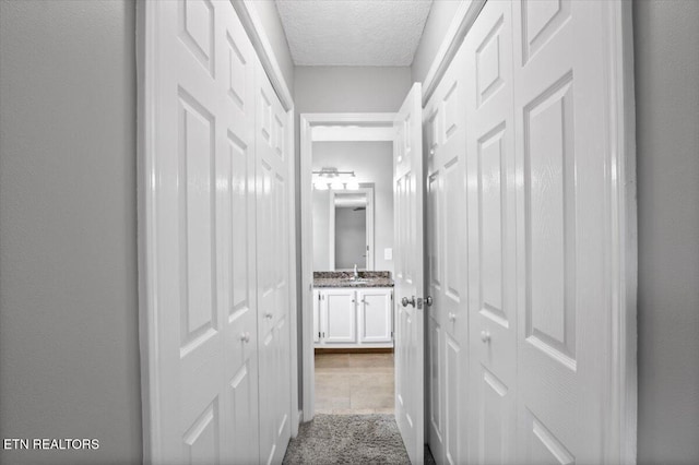 348 Ridge Rd, Caryville, TN 37714 - hall with a sink and a textured ceiling