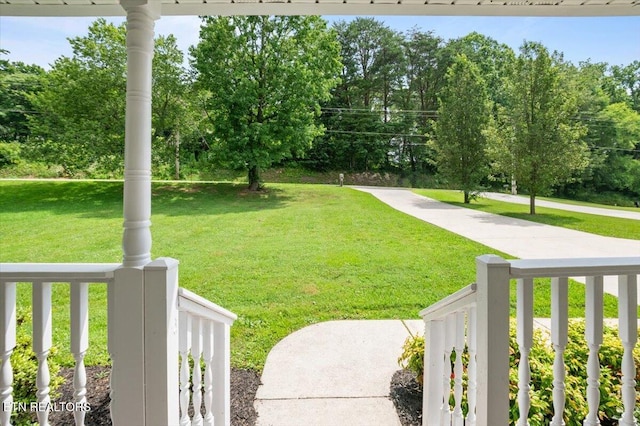 348 Ridge Rd, Caryville, TN 37714 - view of grassy yard featuring covered porch and view of wooded area